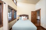 Bedroom 2 offers a queen bed that overlooks the patio and faces the Whitefish River.